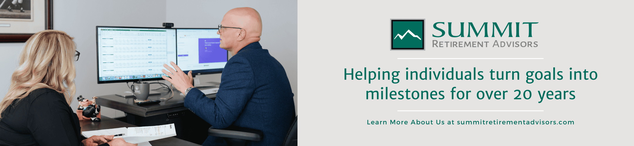 A man and woman sit at a desk in front of dual monitors displaying graphs and documents. The text reads: 